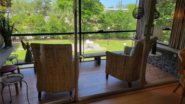 a view of a chairs and table in patio with a yard