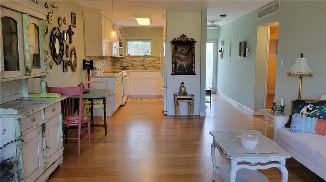 a view of living room filled with furniture and wooden floor