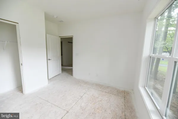 a view of a hallway with closet and bathroom