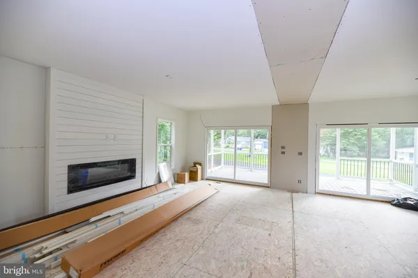 a spacious bedroom with a bed and a large window