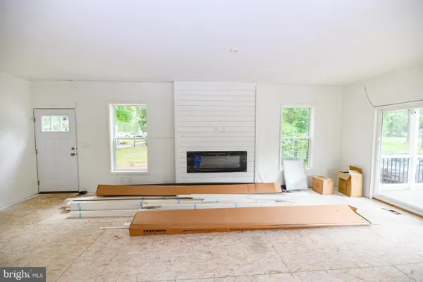 a spacious bedroom with a bed and a large window