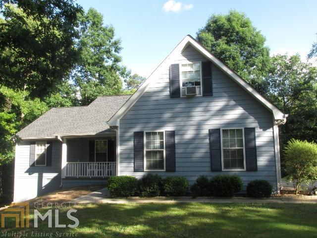 1300 Hillside Road, Unit 2/03 Monroe, GA 30656 - Photo 1 of 1 a view of a yard in front of a house with plants and large tree