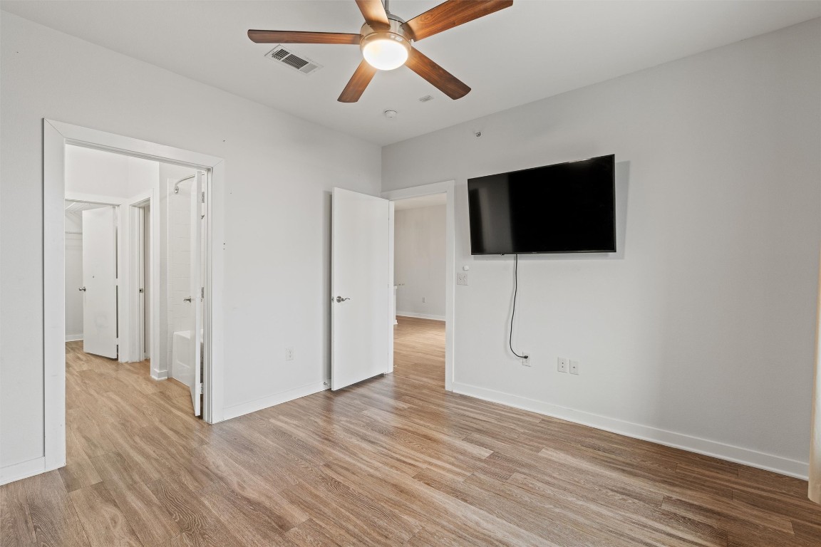 1900 Barton Springs Road, Unit 4037 Austin, TX 78704 - Photo 12 of 34 a view of a livingroom with wooden floor and a flat screen tv