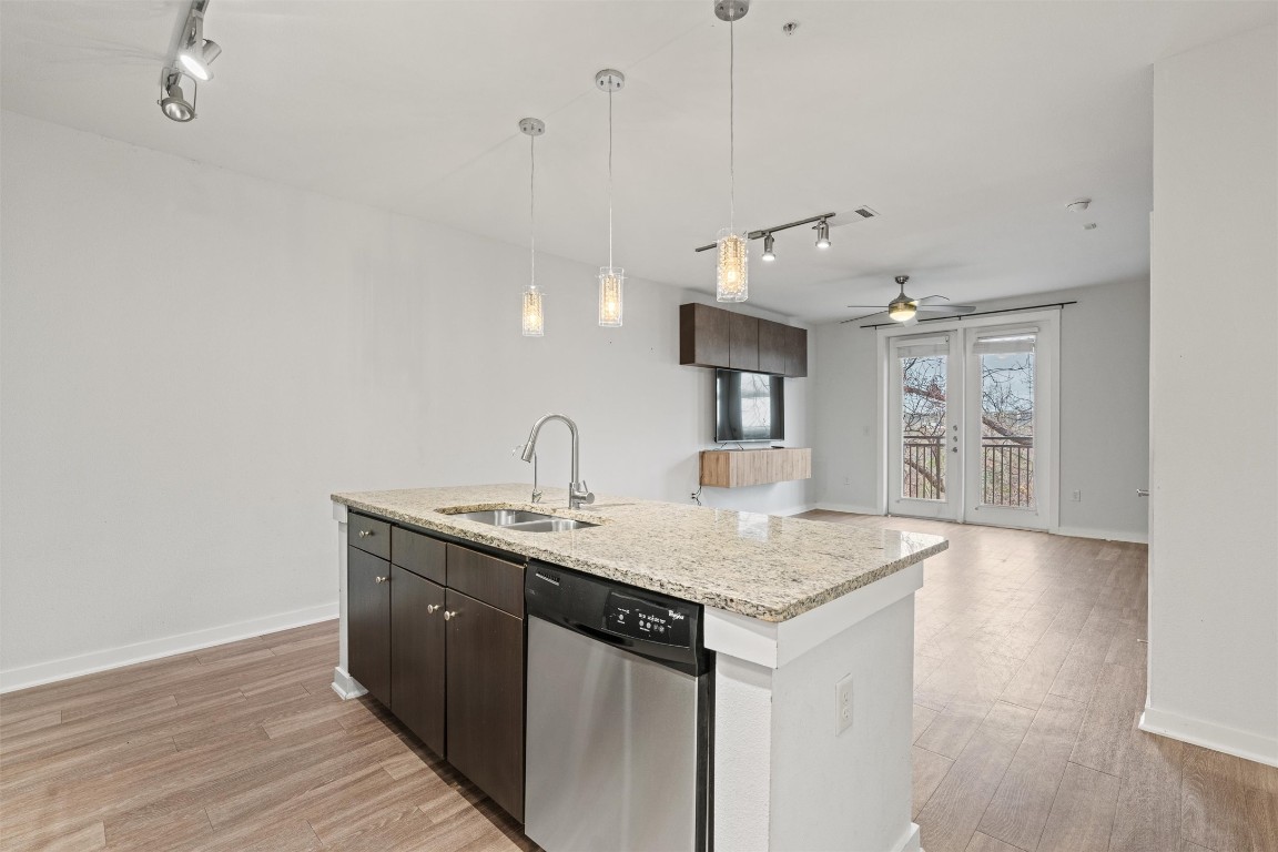 1900 Barton Springs Road, Unit 4037 Austin, TX 78704 - Photo 3 of 34 a kitchen with a sink a counter space and wooden floor