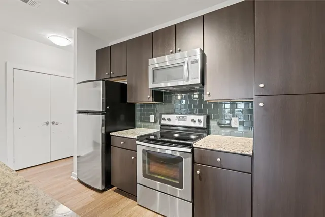 a kitchen with a stove microwave and refrigerator