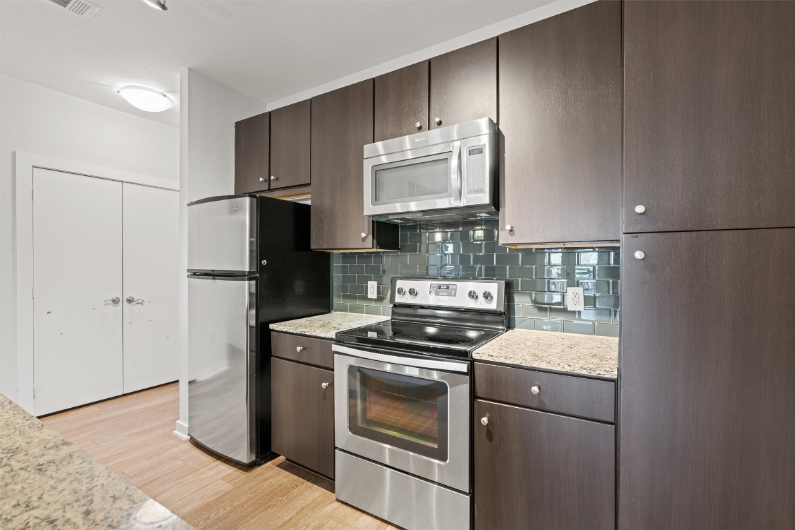 1900 Barton Springs Road, Unit 4037 Austin, TX 78704 - Photo 5 of 34 a kitchen with a stove microwave and refrigerator