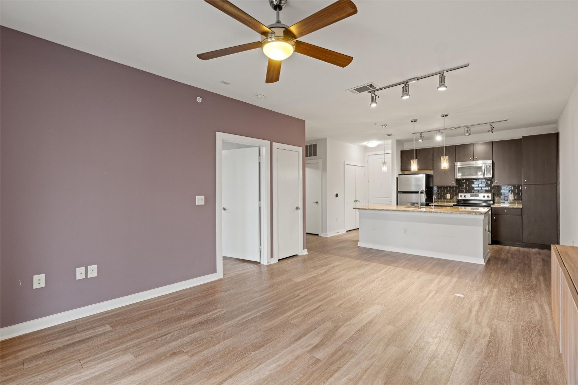 1900 Barton Springs Road, Unit 4037 Austin, TX 78704 - Photo 10 of 34 a view of kitchen with wooden floor and window