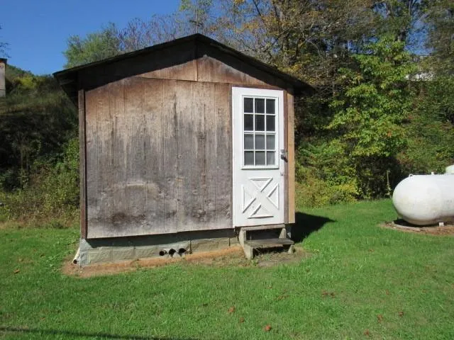 a view of an empty room with a fireplace and a window