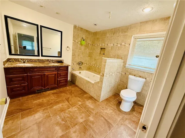 a bathroom with a bathtub sink and toilet