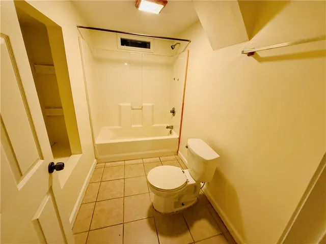 a bathroom with a shower and a toilet