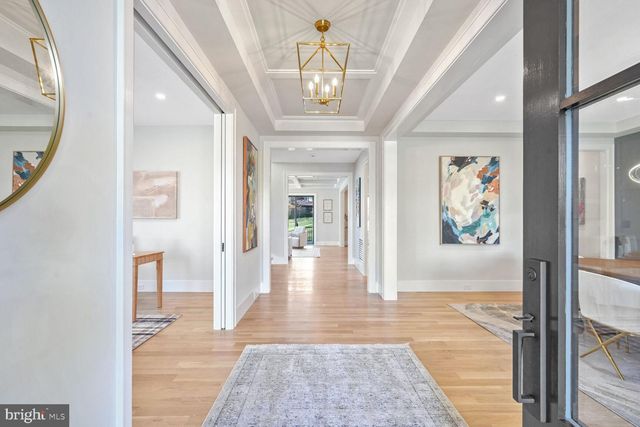 a living room with a couch and a chandelier