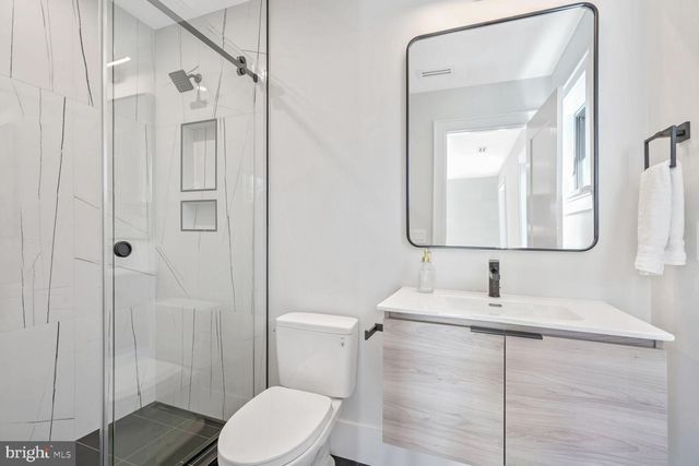 a view of a kitchen with a sink and a refrigerator