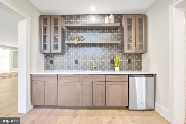 a view of a room with wooden floor and a ceiling fan