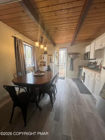 a view of a dining room with furniture window and wooden floor