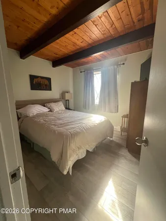 a bedroom with a bed next to a window