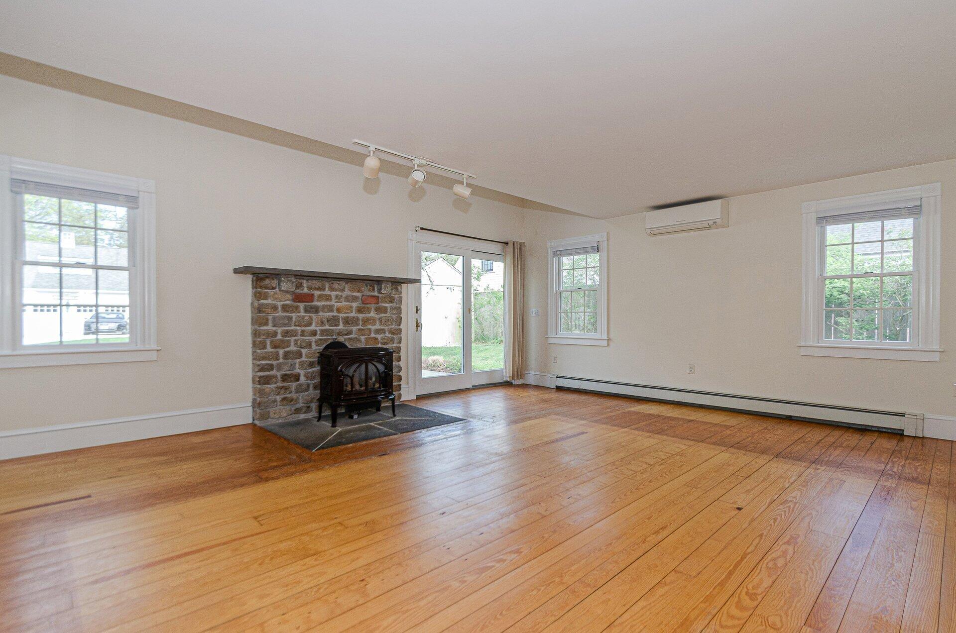 1089 Main Street Cotuit, MA 02635 - Photo 15 of 41 an empty room with windows and fireplace