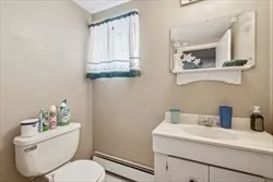 a bathroom with a toilet sink and mirror