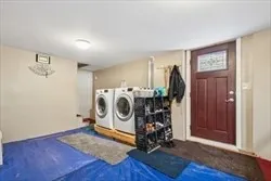 a utility room with fridge dryer and washer