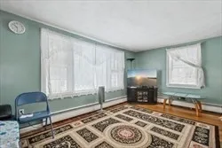 a bedroom with a bed table and chair