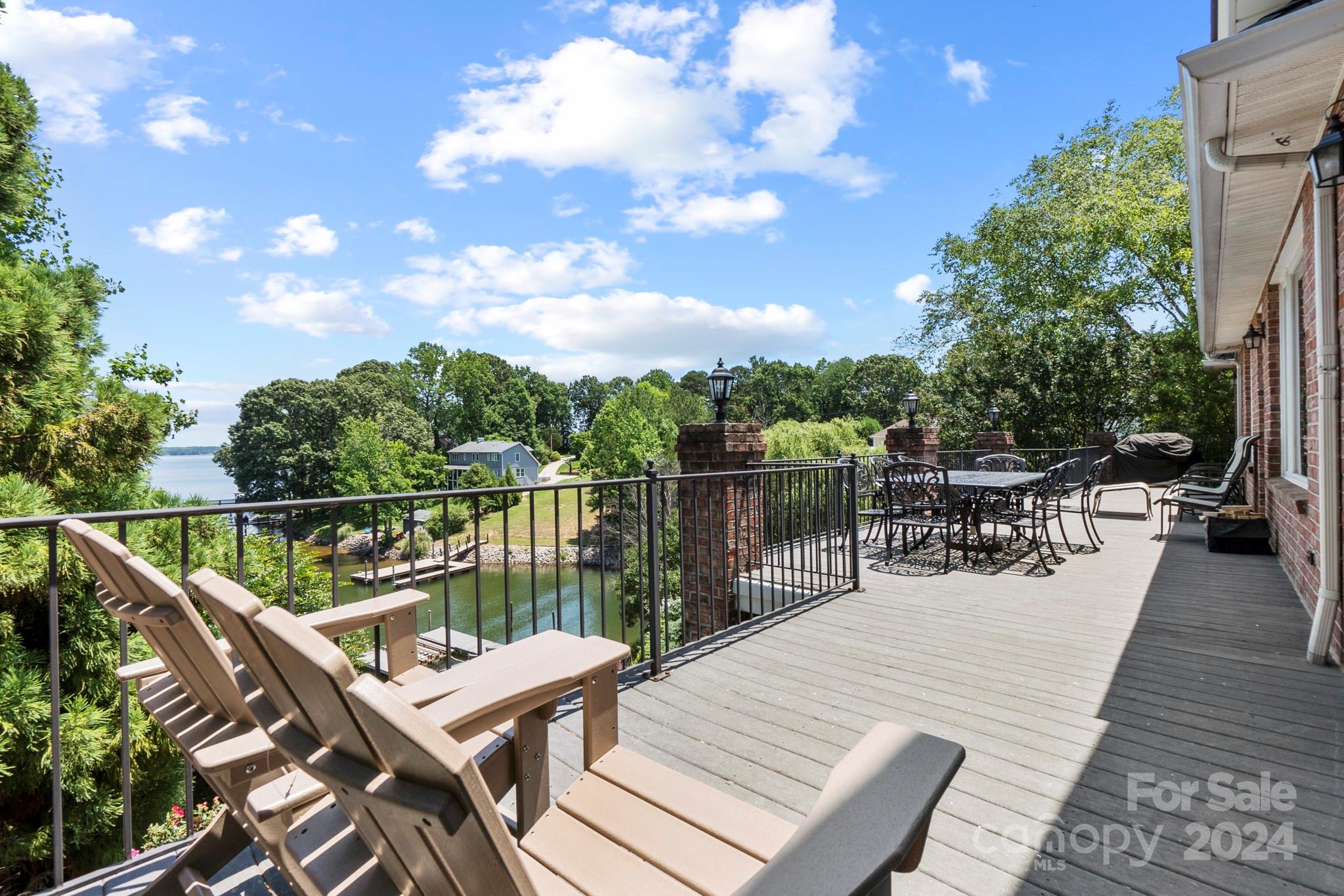 5008 Webbs Chapel Church Road Denver, NC 28037 - Photo 14 of 48 a view of a roof deck with table and chairs a barbeque with wooden floor and fence