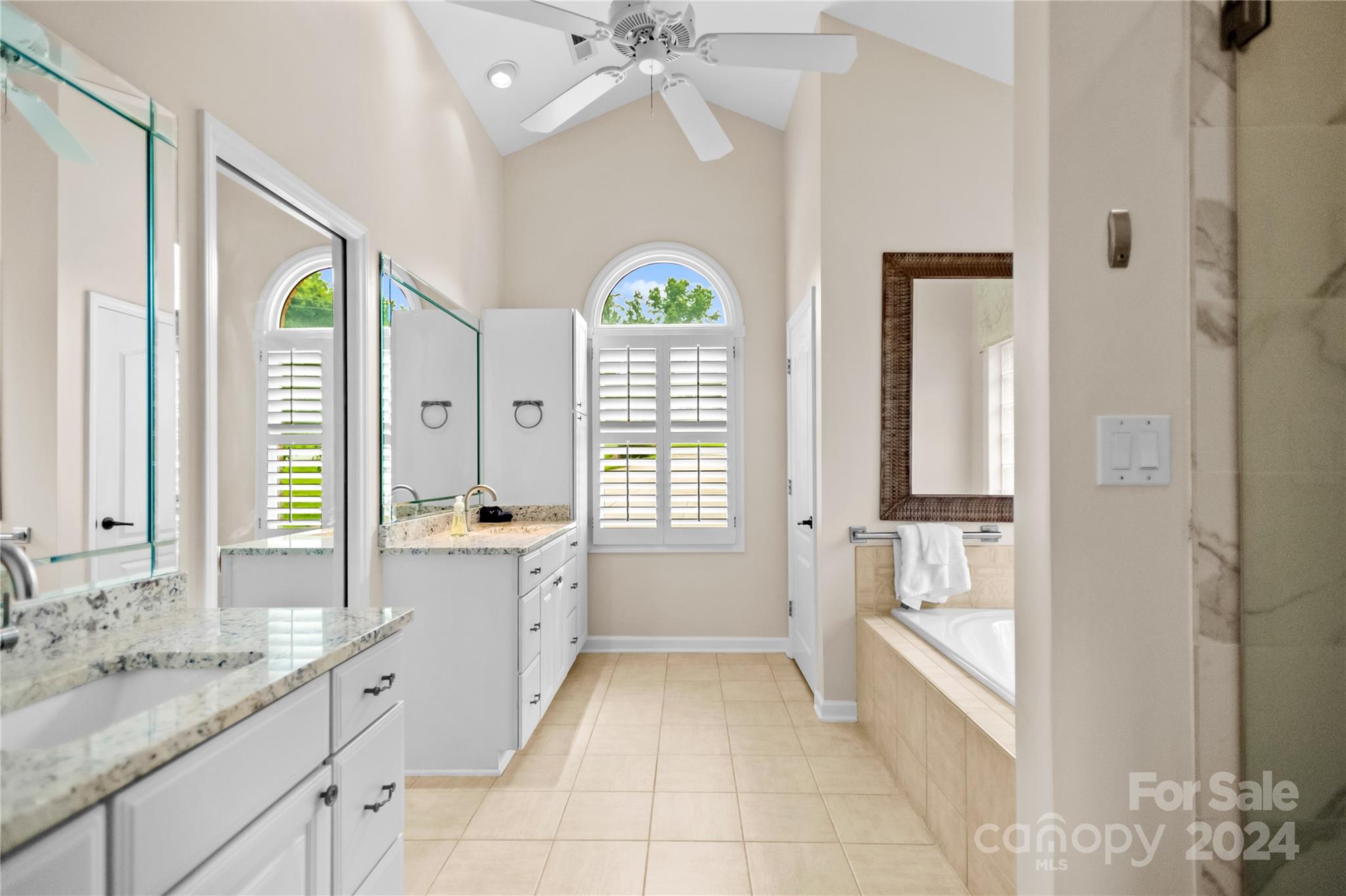 5008 Webbs Chapel Church Road Denver, NC 28037 - Photo 22 of 48 a spacious bathroom with a granite countertop tub shower a sink and a large mirror