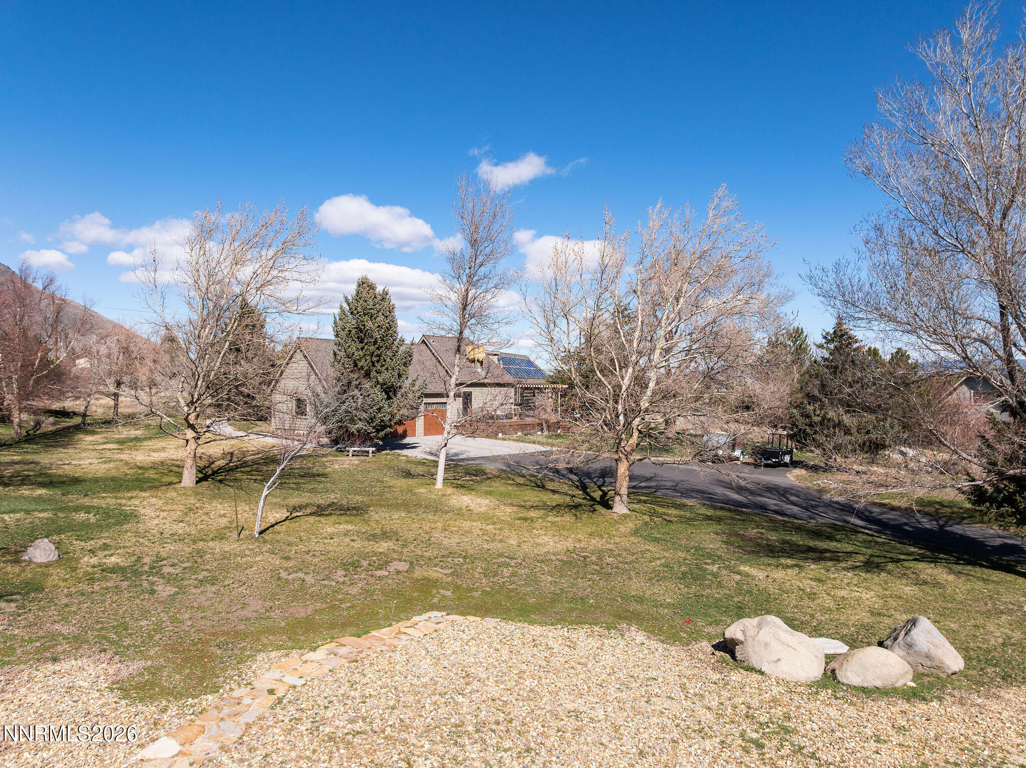 220 Limousin Court Genoa, NV 89411 - Photo 1 of 77 a view of a yard with large trees