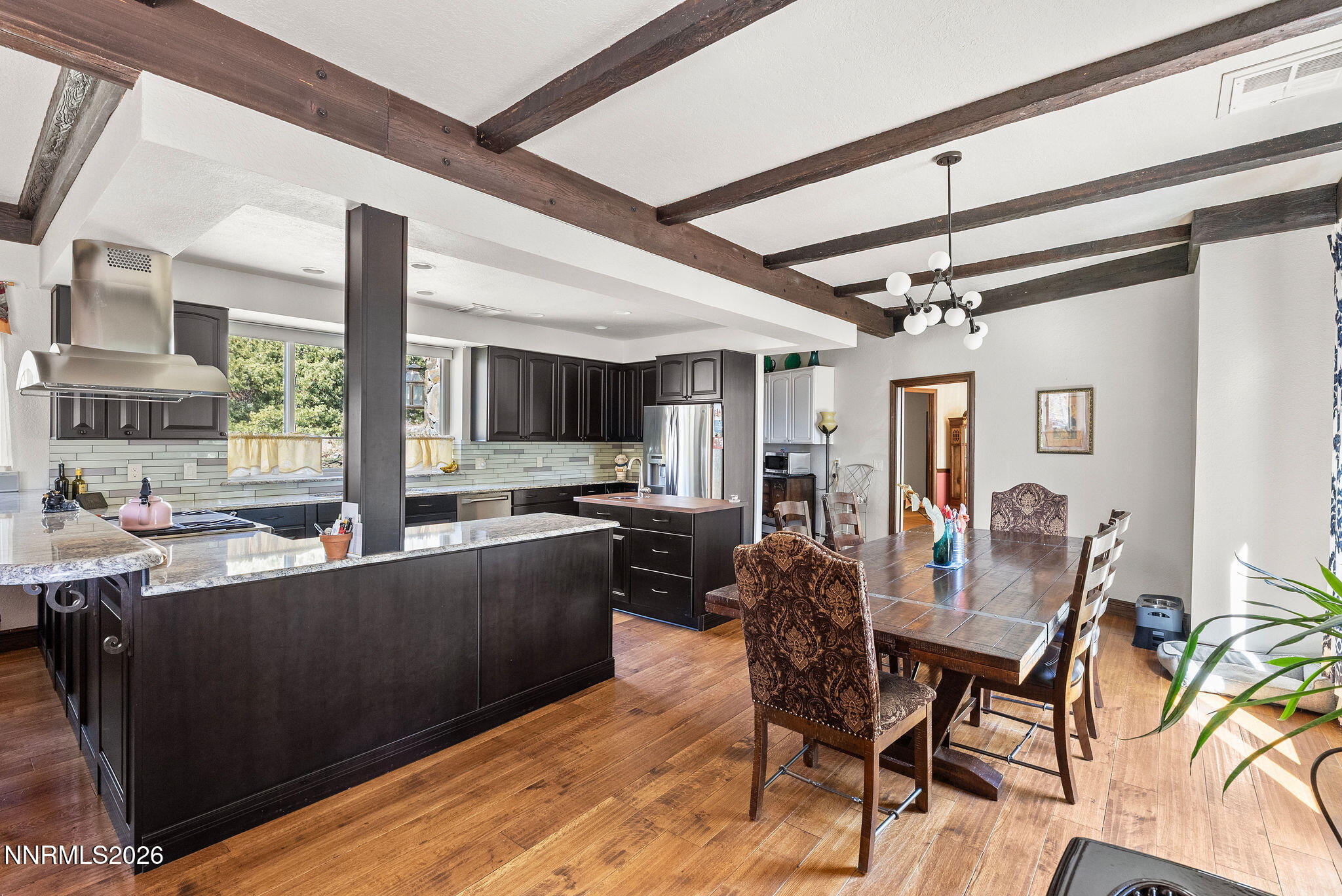220 Limousin Court Genoa, NV 89411 - Photo 19 of 77 a view of a dining room with furniture a kitchen and chandelier