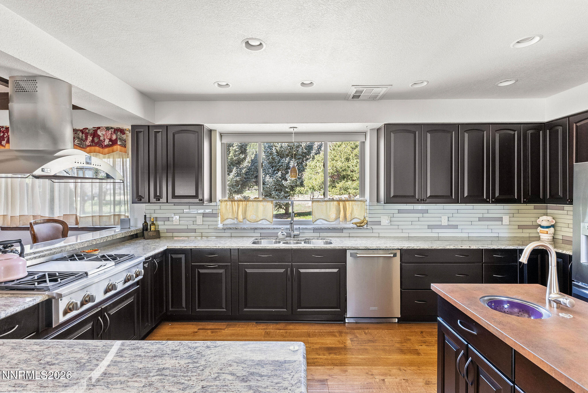 220 Limousin Court Genoa, NV 89411 - Photo 20 of 77 a kitchen with stainless steel appliances granite countertop a sink stove and refrigerator