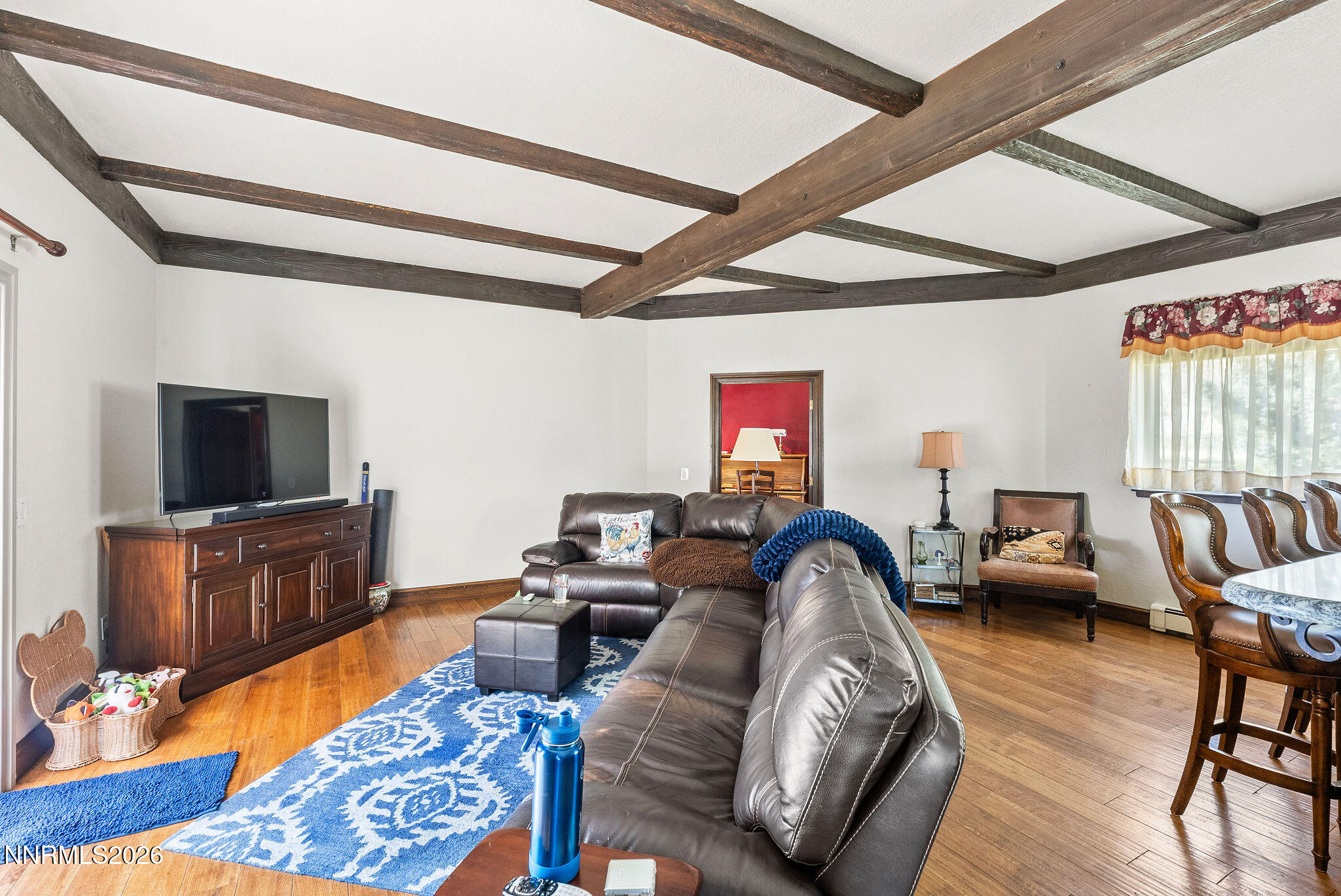 220 Limousin Court Genoa, NV 89411 - Photo 29 of 77 a living room with furniture a flat screen tv and wooden floor