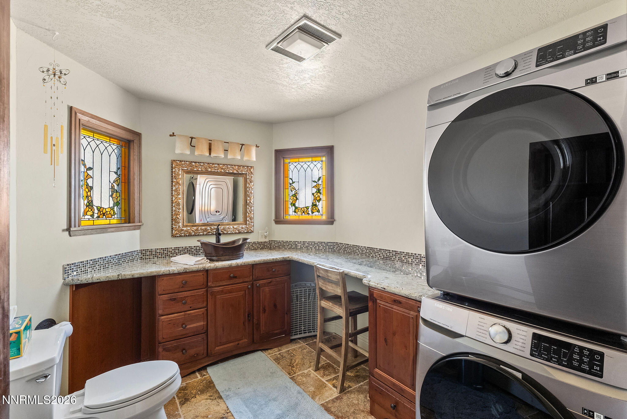 220 Limousin Court Genoa, NV 89411 - Photo 65 of 77 a bathroom with a granite countertop toilet sink and mirror