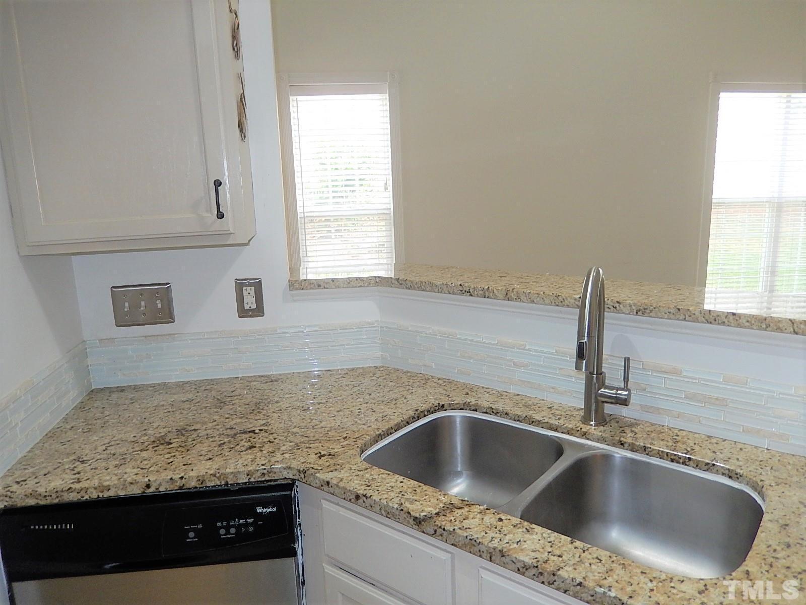 4717 Delta Ridge Court Raleigh, NC 27612 - Photo 9 of 30 a kitchen with granite countertop a sink and window