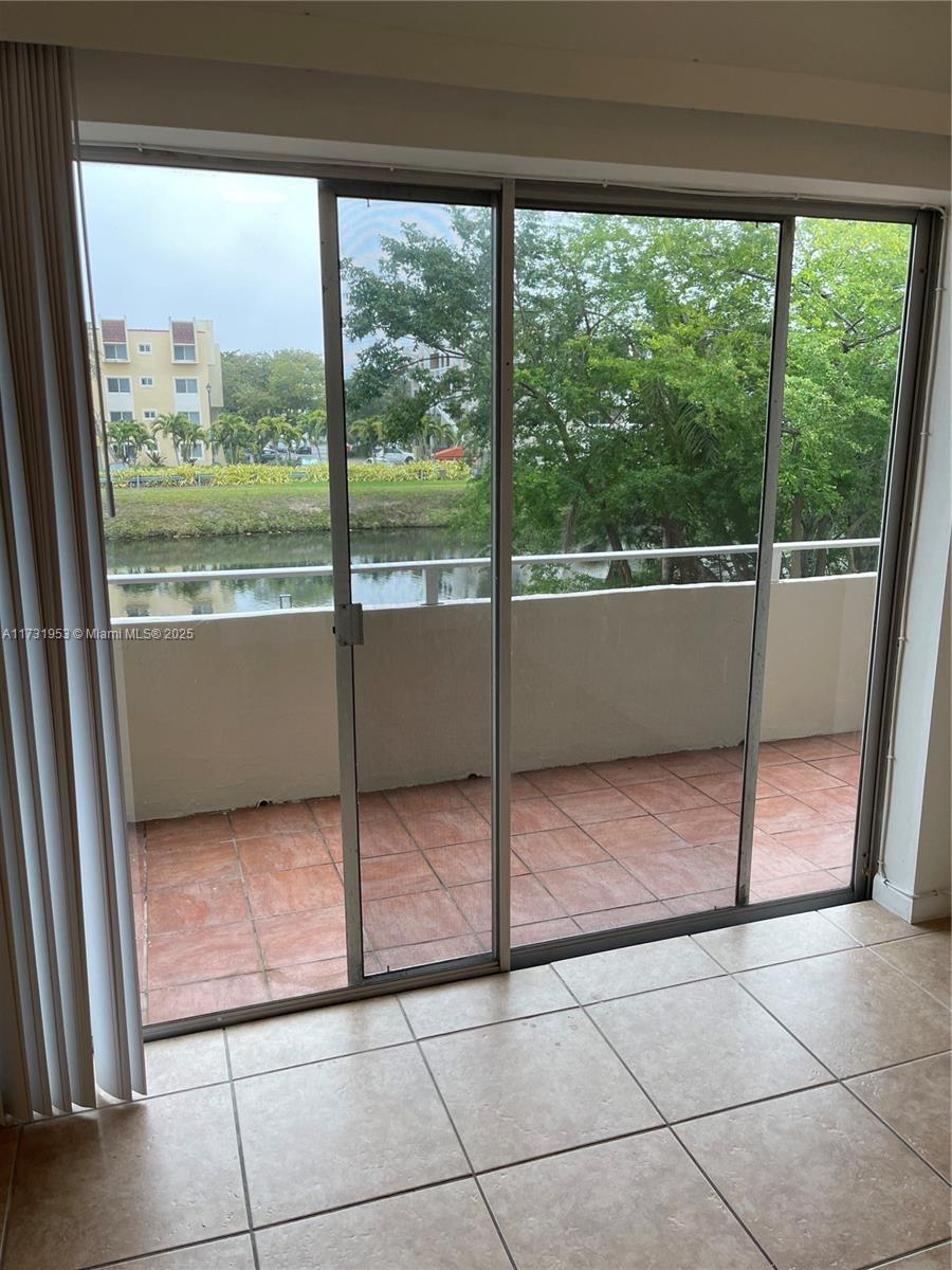 7787 Southwest 86th Street, Unit E211 Miami, FL 33143 - Photo 12 of 27 a view of a room that has a bed in it