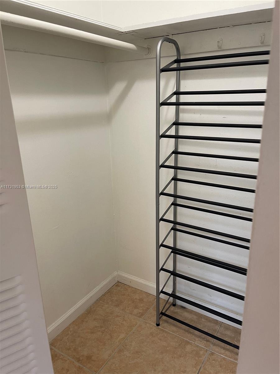 7787 Southwest 86th Street, Unit E211 Miami, FL 33143 - Photo 14 of 27 a view of a room with white walls
