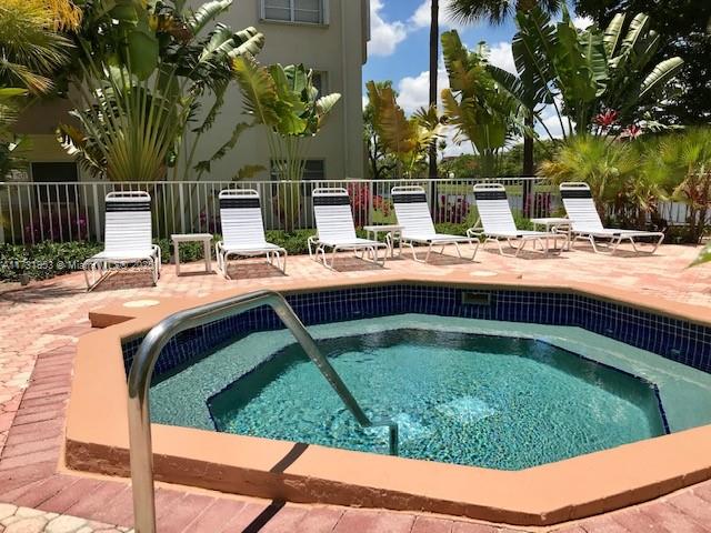 7787 Southwest 86th Street, Unit E211 Miami, FL 33143 - Photo 21 of 27 a view of yard with swimming pool and outdoor seating