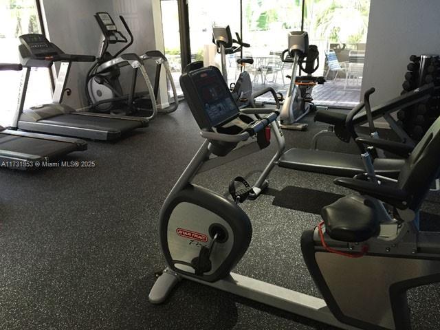 7787 Southwest 86th Street, Unit E211 Miami, FL 33143 - Photo 26 of 27 a view of a room with gym equipment