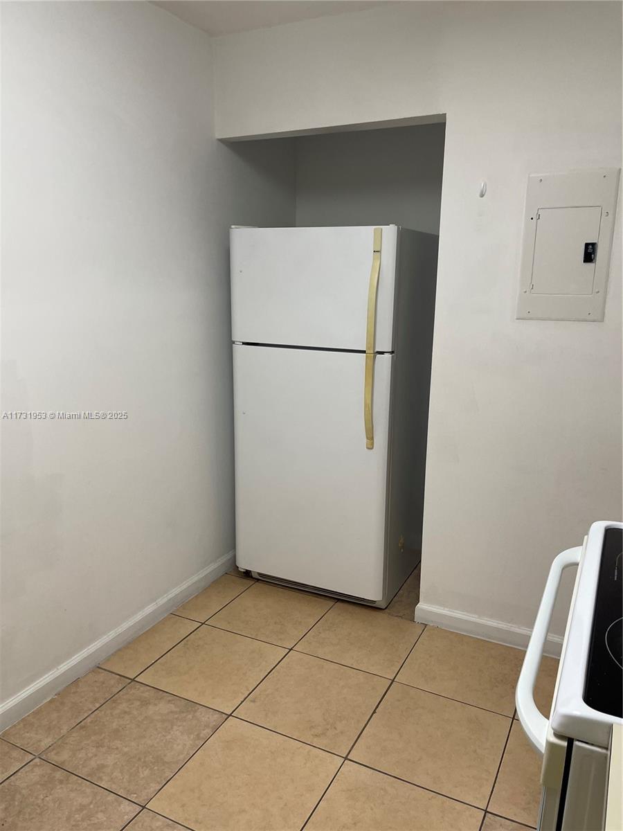 7787 Southwest 86th Street, Unit E211 Miami, FL 33143 - Photo 4 of 27 a view of a storage & utility room with washer and dryer