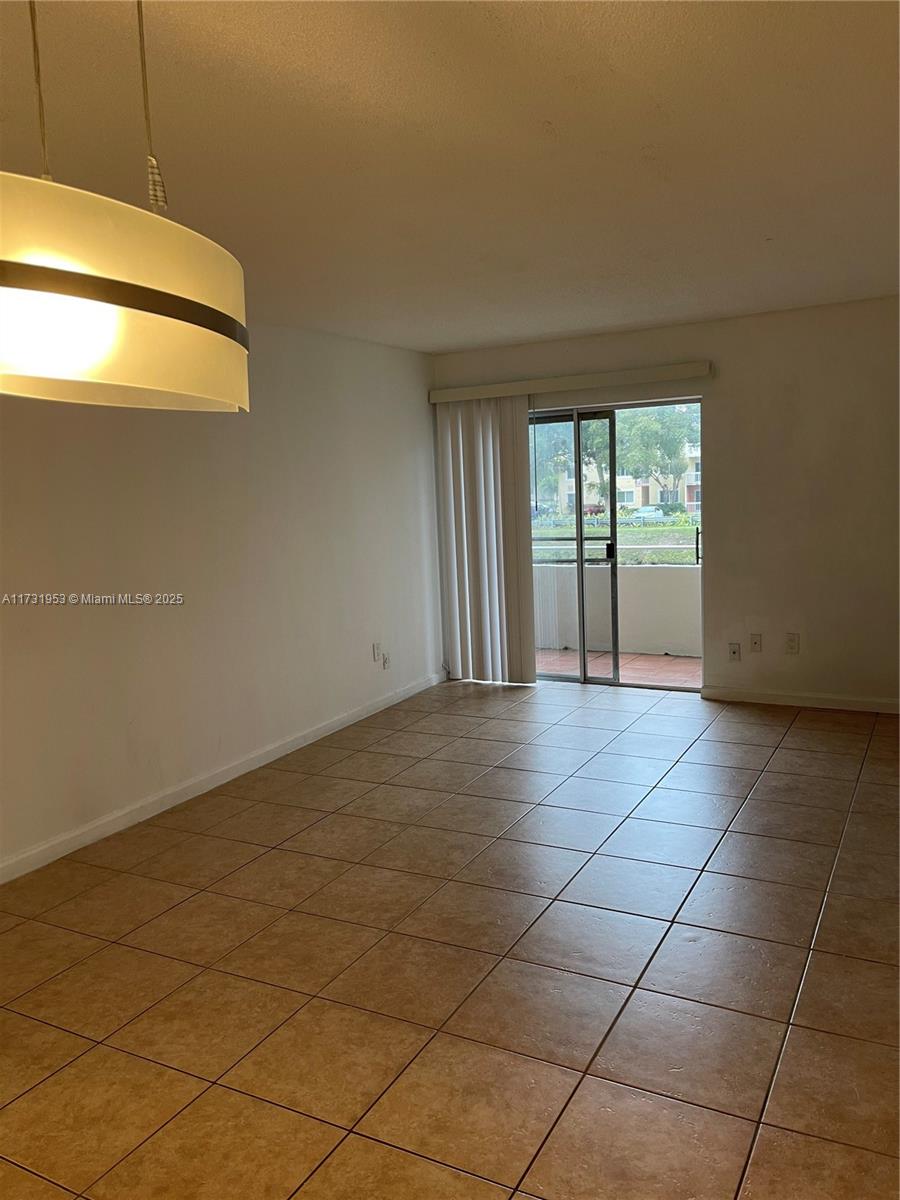 7787 Southwest 86th Street, Unit E211 Miami, FL 33143 - Photo 5 of 27 a view of an empty room with a window