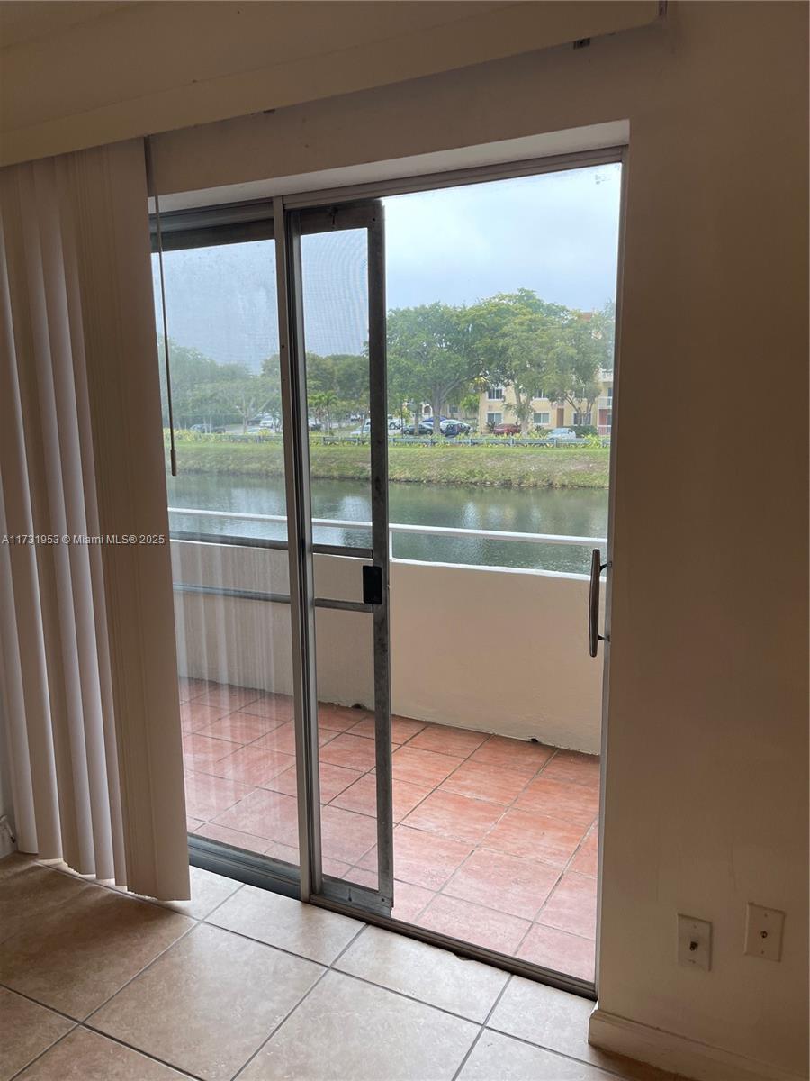 7787 Southwest 86th Street, Unit E211 Miami, FL 33143 - Photo 6 of 27 a view of an empty room and window