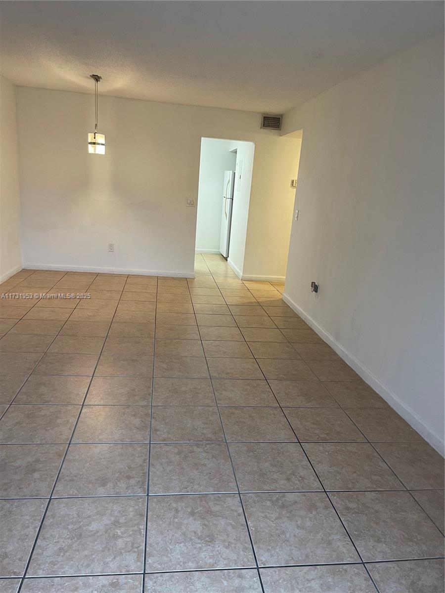 7787 Southwest 86th Street, Unit E211 Miami, FL 33143 - Photo 8 of 27 a view of an empty room with a window