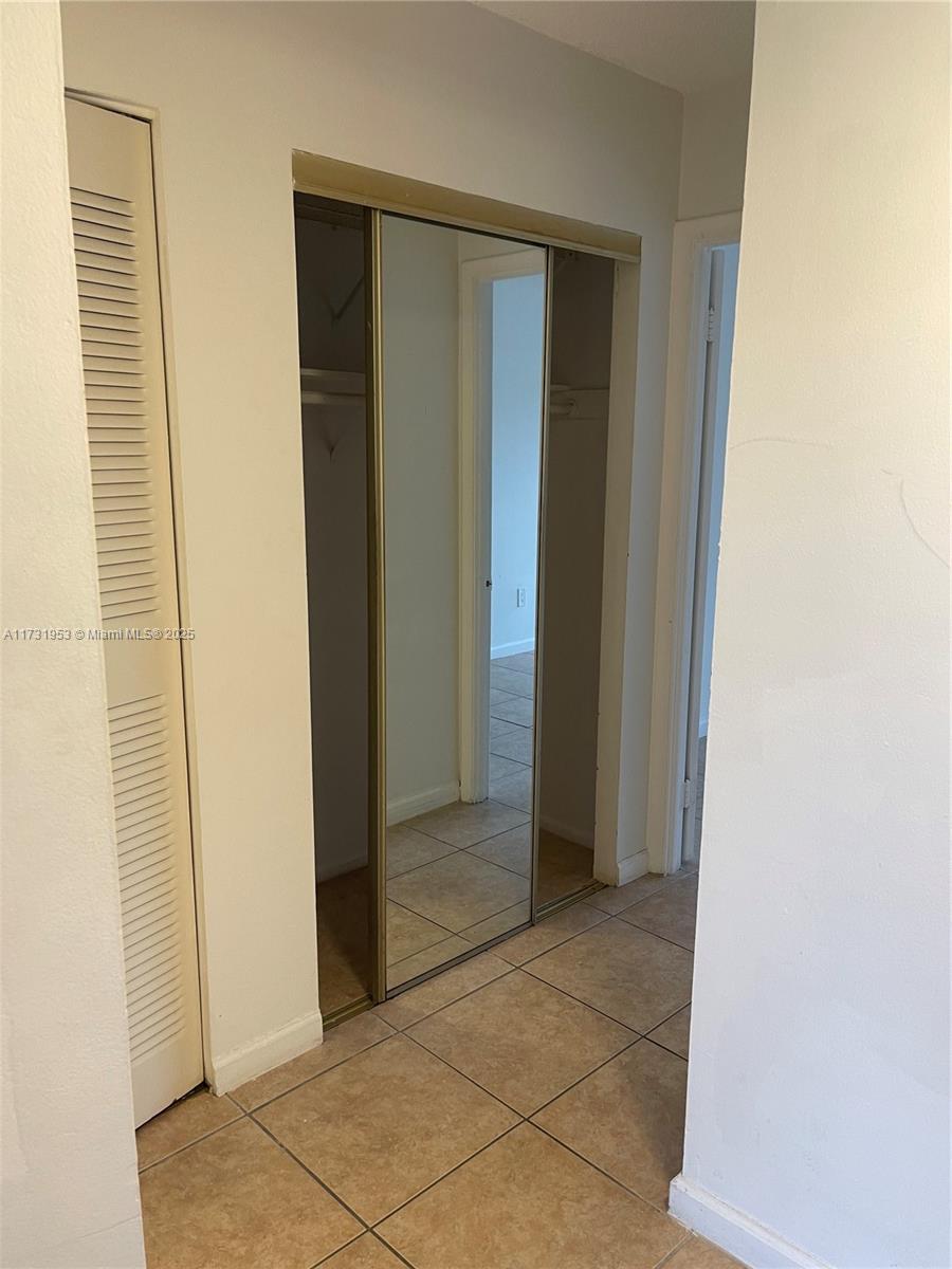 7787 Southwest 86th Street, Unit E211 Miami, FL 33143 - Photo 9 of 27 a view of entryway with bathroom