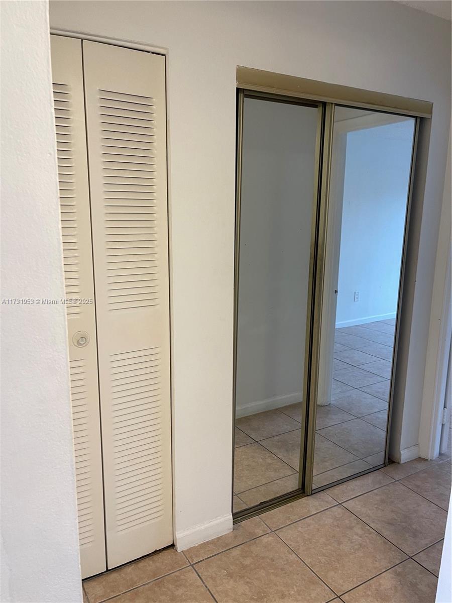 7787 Southwest 86th Street, Unit E211 Miami, FL 33143 - Photo 10 of 27 an entryway with a glass door