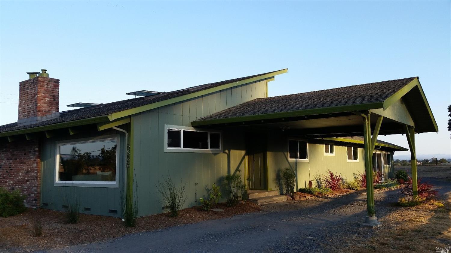 5860 Hall Road Santa Rosa, CA 95401 - Photo 1 of 1 a backyard of a house with table and chairs