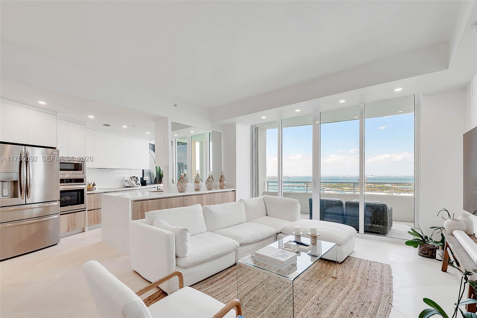 848 Brickell Key Drive, Unit 4002 Miami, FL 33131 - Photo 1 of 18 a living room with furniture stove and a large window