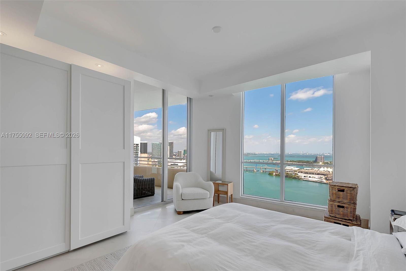 848 Brickell Key Drive, Unit 4002 Miami, FL 33131 - Photo 11 of 18 a spacious bedroom with a bed and a large window