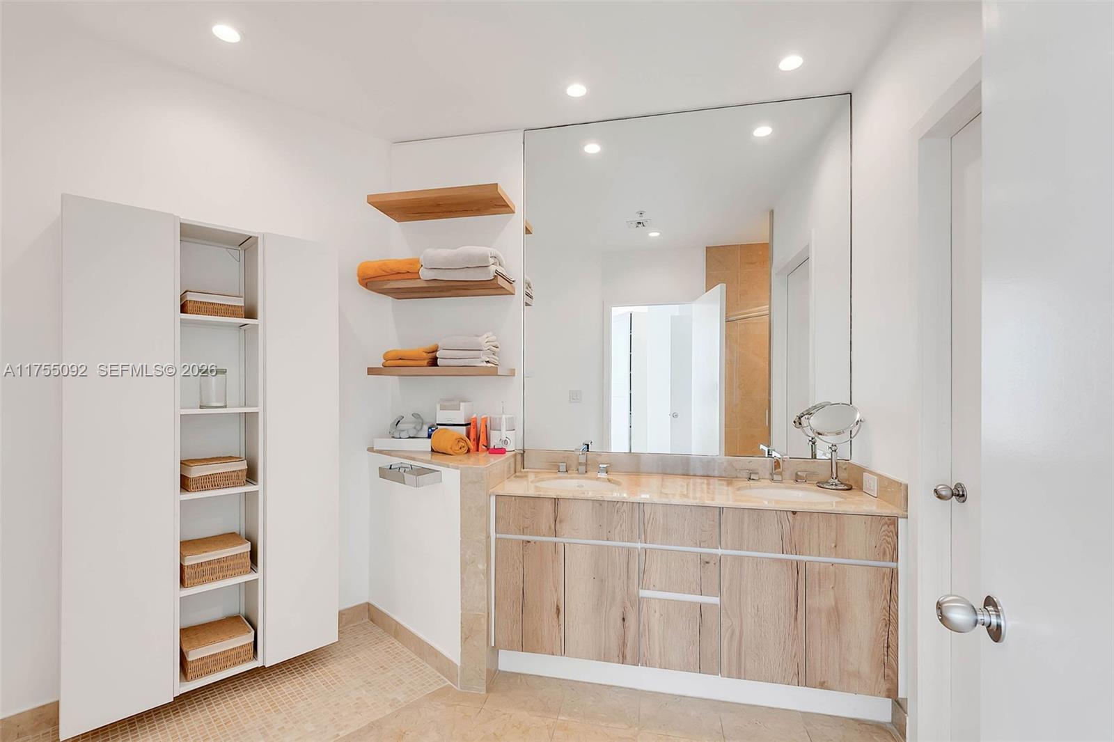 848 Brickell Key Drive, Unit 4002 Miami, FL 33131 - Photo 12 of 18 a bathroom with a sink and a mirror