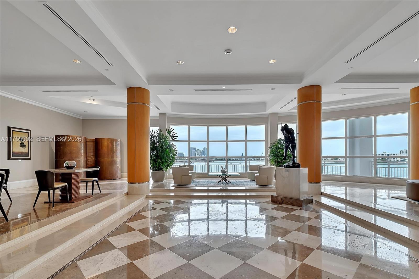 848 Brickell Key Drive, Unit 4002 Miami, FL 33131 - Photo 14 of 18 a living room with furniture and large windows