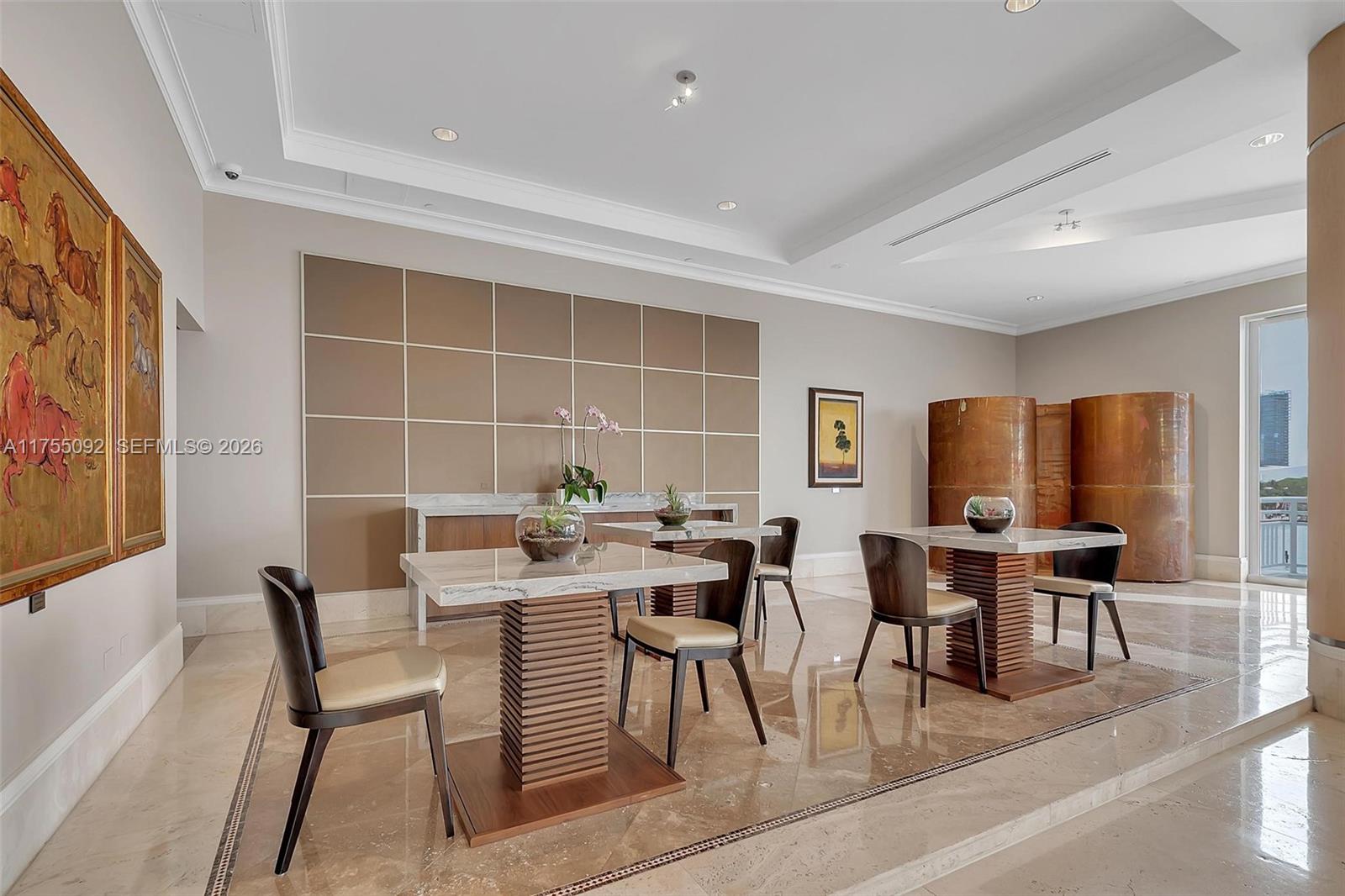 848 Brickell Key Drive, Unit 4002 Miami, FL 33131 - Photo 15 of 18 a view of a dining room with furniture and chandelier