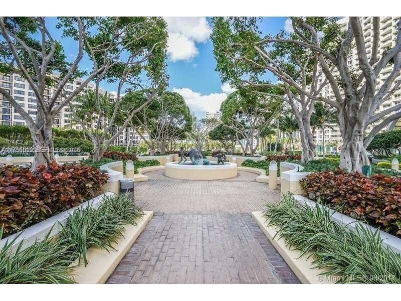 848 Brickell Key Drive, Unit 4002 Miami, FL 33131 - Photo 17 of 18 a view of swimming pool with outdoor seating and plants