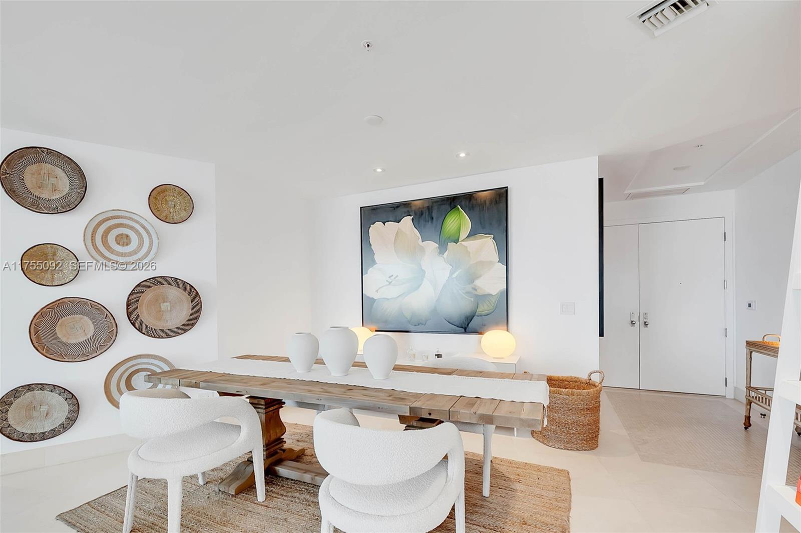 848 Brickell Key Drive, Unit 4002 Miami, FL 33131 - Photo 6 of 18 a living room with kitchen and a table