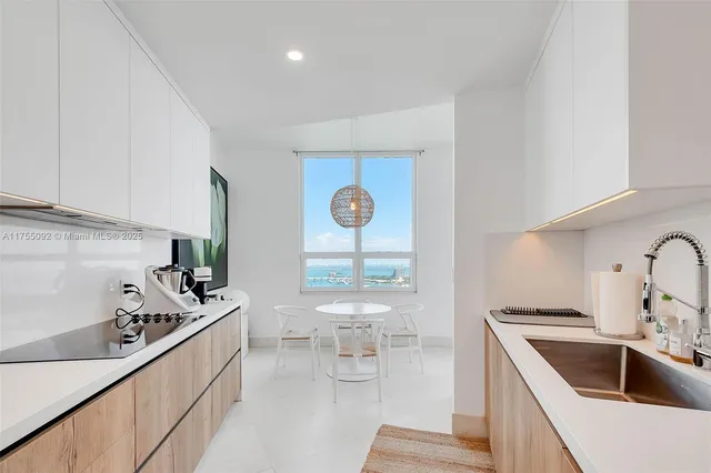 a kitchen with a sink cabinets and appliances